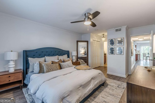 bedroom featuring crown molding, wood-type flooring, a closet, and ceiling fan