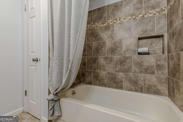 bathroom with shower / tub combo with curtain and tile patterned floors