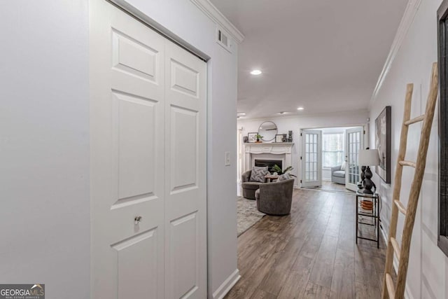 hallway with crown molding and wood-type flooring