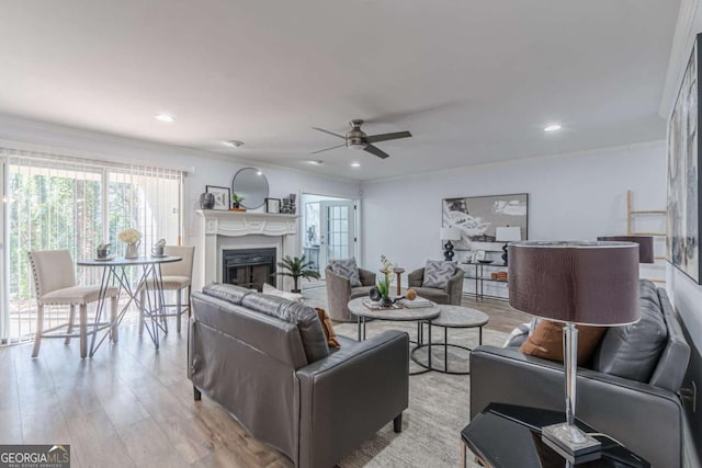 living room featuring ornamental molding and light hardwood / wood-style floors