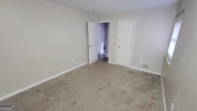 spare room featuring light colored carpet