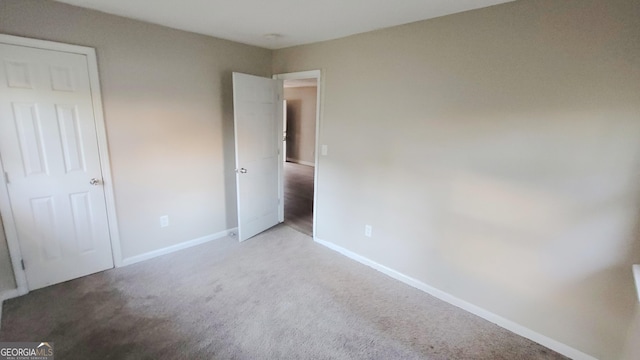 unfurnished bedroom with light colored carpet