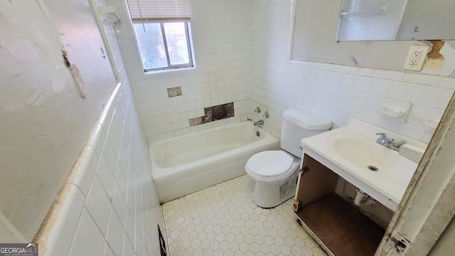 bathroom featuring tile walls, sink, tile patterned floors, and toilet