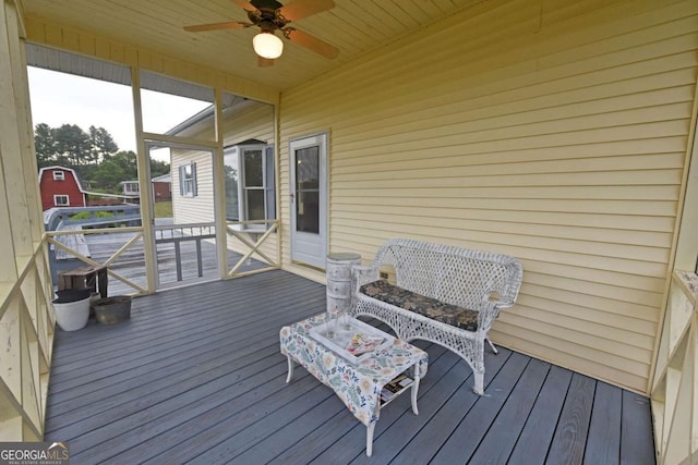 wooden terrace featuring ceiling fan