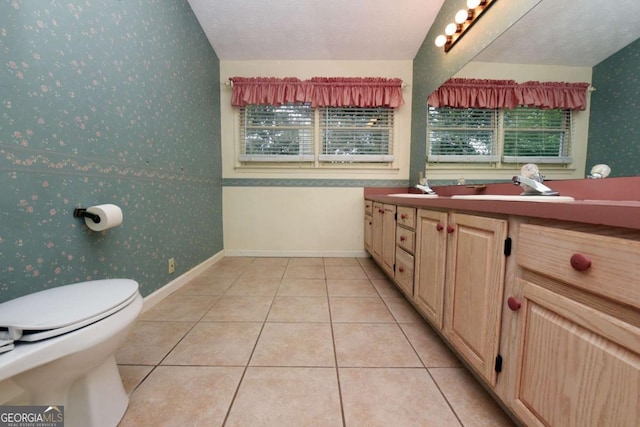 bathroom featuring tile patterned floors, toilet, a textured ceiling, and vanity