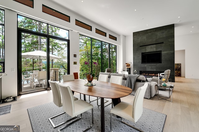 dining area featuring a fireplace and light hardwood / wood-style floors