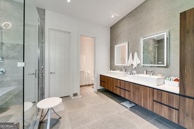 bathroom featuring decorative backsplash, tile patterned flooring, vanity, walk in shower, and toilet