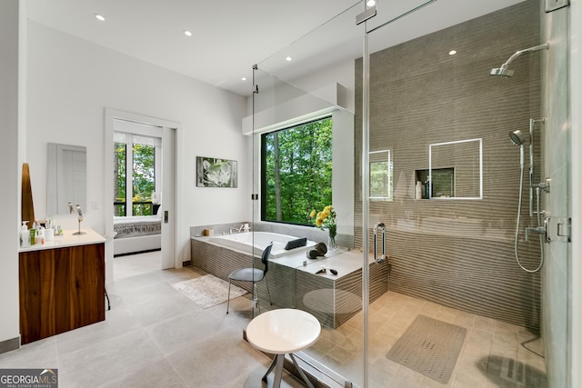 bathroom featuring tile patterned floors, vanity, and independent shower and bath