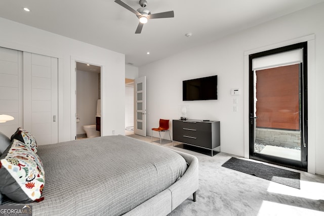 bedroom with light carpet, connected bathroom, and ceiling fan