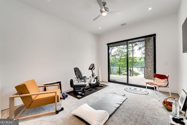 exercise room with ceiling fan and carpet flooring