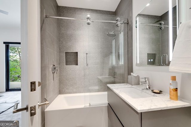 bathroom with vanity and bath / shower combo with glass door