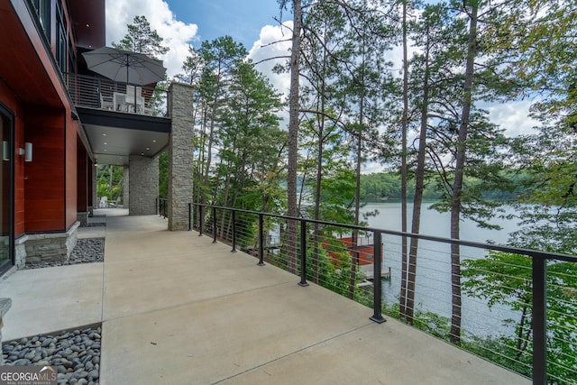 view of patio / terrace with a water view and a balcony