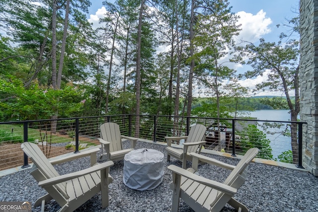 view of patio with a balcony and a water view