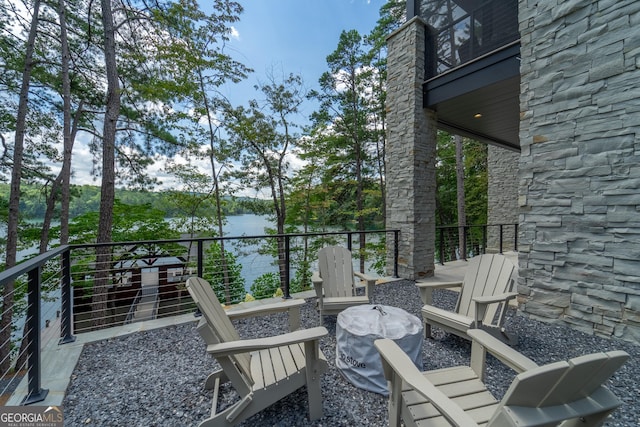 view of patio / terrace featuring a water view and a balcony