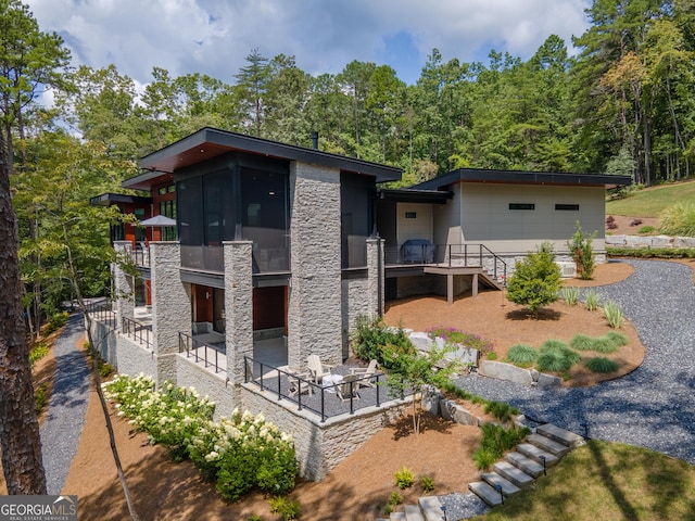 view of front of home featuring a patio and a sunroom