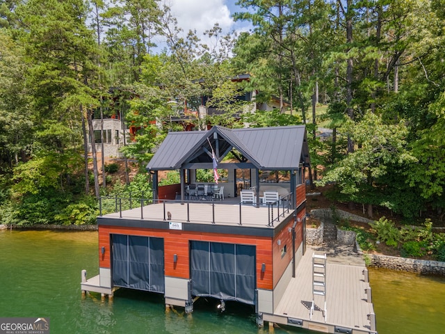 back of property featuring a gazebo and a water view