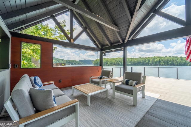 deck featuring a water view and outdoor lounge area