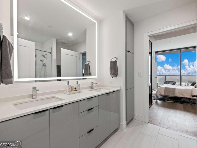 bathroom with a shower with door and vanity