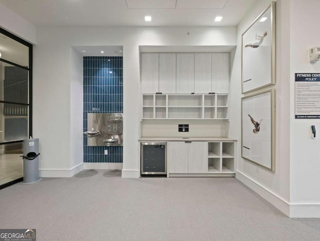 living room featuring wine cooler and light carpet