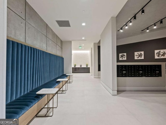 hallway featuring mail boxes and track lighting