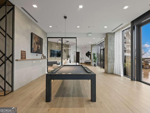 recreation room featuring expansive windows, pool table, and light hardwood / wood-style floors