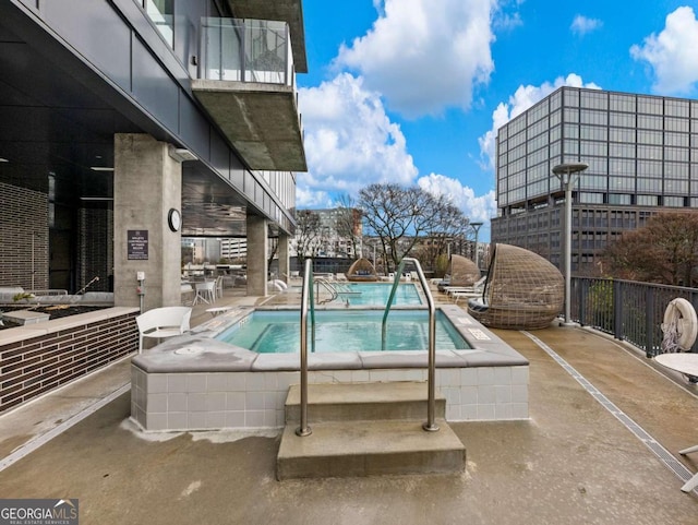 view of pool featuring a community hot tub and a patio