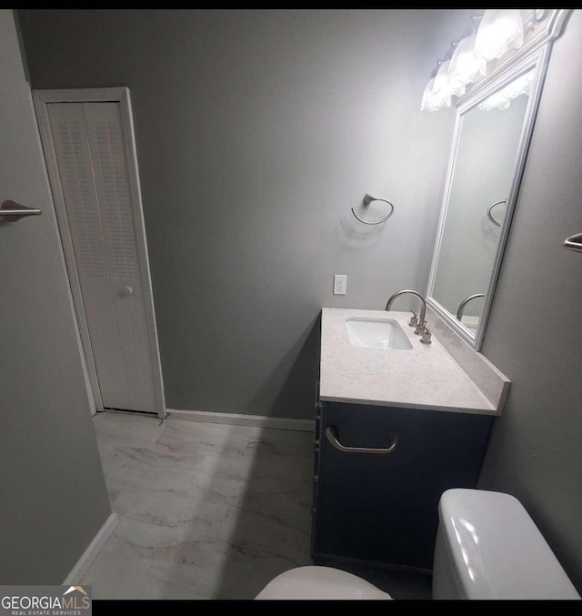 bathroom featuring vanity and toilet