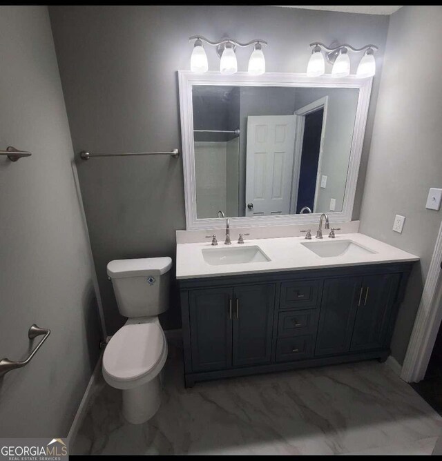 bathroom featuring vanity, toilet, and walk in shower