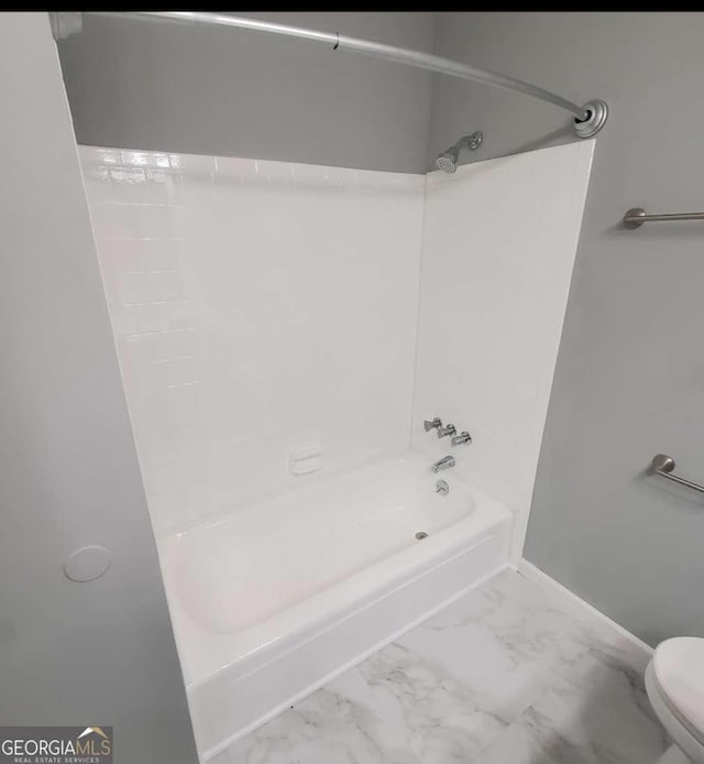 bathroom featuring toilet and washtub / shower combination