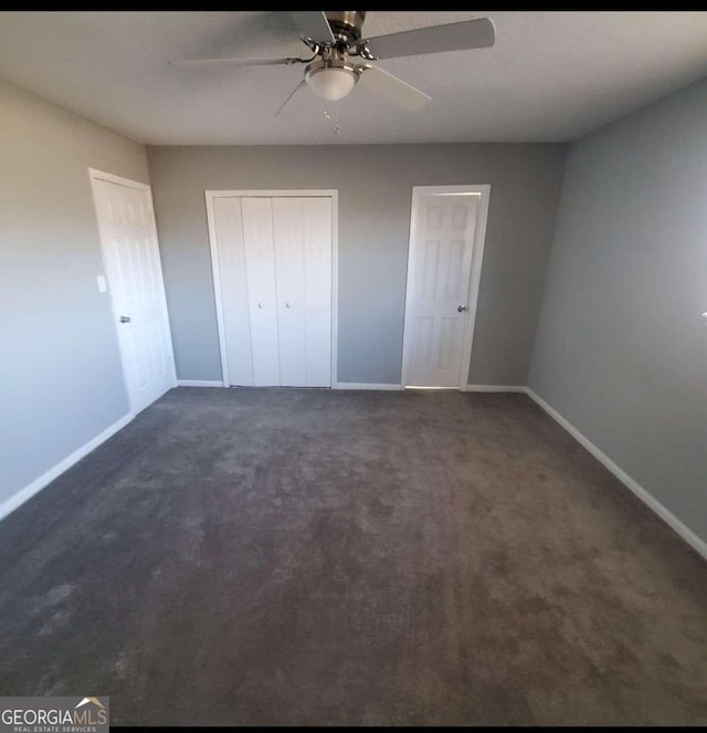 unfurnished bedroom featuring a closet, ceiling fan, and dark colored carpet