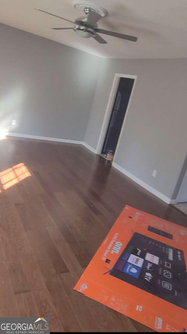 spare room with ceiling fan and dark hardwood / wood-style floors