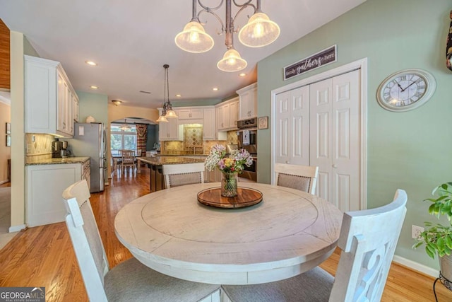 dining space with light wood-type flooring