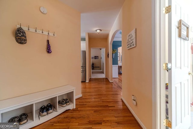 corridor with hardwood / wood-style flooring