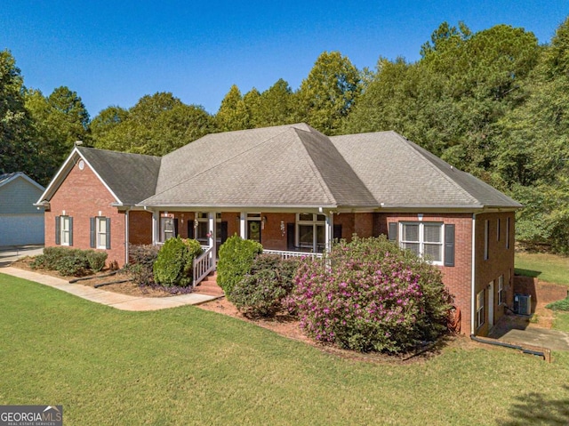 view of front of house with covered porch and a front lawn