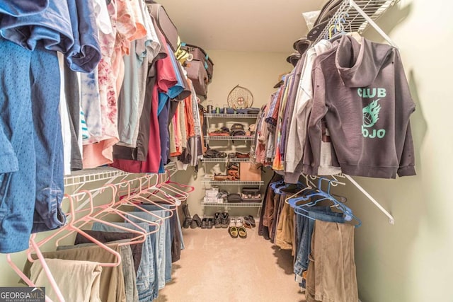 walk in closet featuring carpet floors