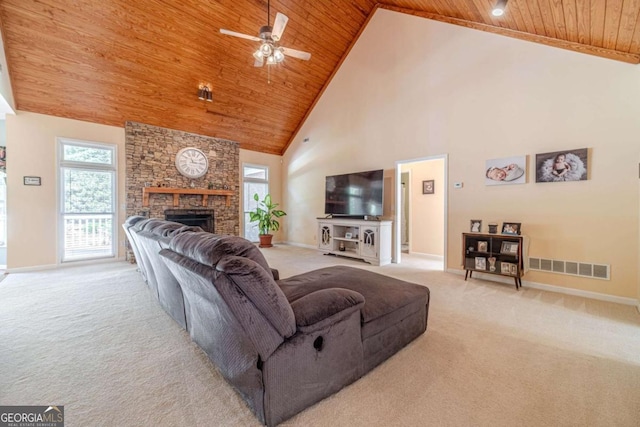 living room with light colored carpet, a stone fireplace, high vaulted ceiling, and wooden ceiling