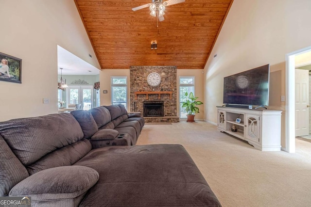 carpeted living room featuring high vaulted ceiling, a fireplace, and wooden ceiling