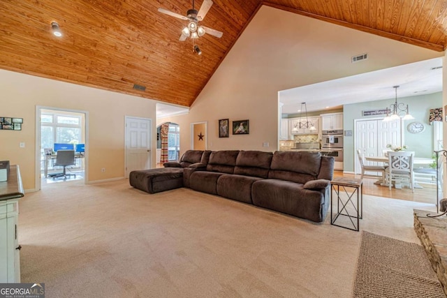 living room featuring high vaulted ceiling, light colored carpet, wooden ceiling, and ceiling fan