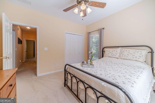 bedroom featuring light carpet, a closet, and ceiling fan