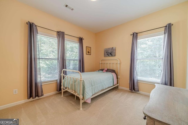 bedroom featuring light carpet