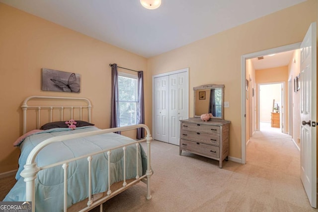 bedroom featuring light carpet and a closet