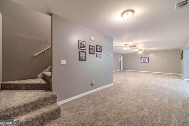 interior space featuring carpet floors and ceiling fan