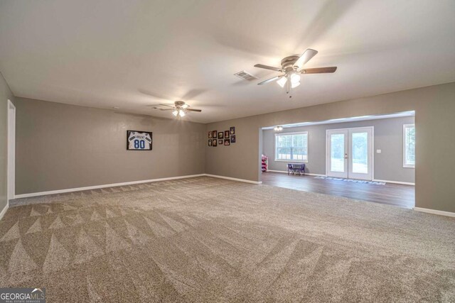 carpeted empty room with ceiling fan and french doors