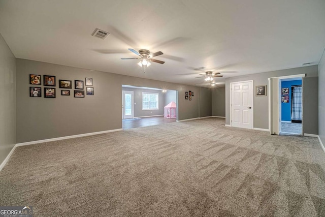 carpeted spare room with ceiling fan