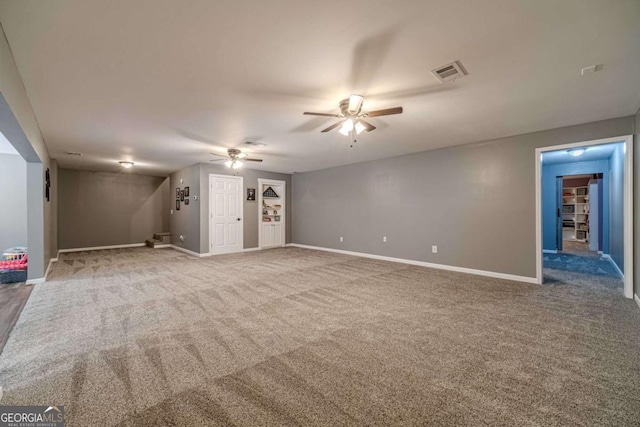 unfurnished living room with ceiling fan and carpet floors