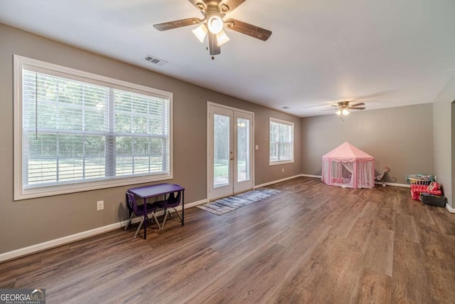 game room with hardwood / wood-style flooring, french doors, and ceiling fan