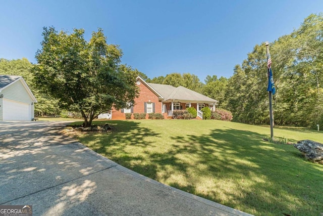 ranch-style house with a porch, a garage, and a front yard