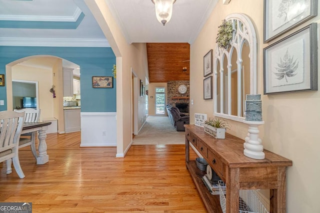 corridor featuring ornamental molding and light wood-type flooring