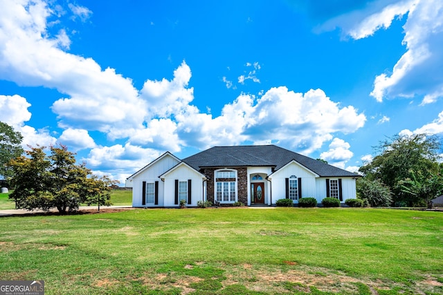 view of front of property with a front lawn, board and batten siding, and a shingled roof