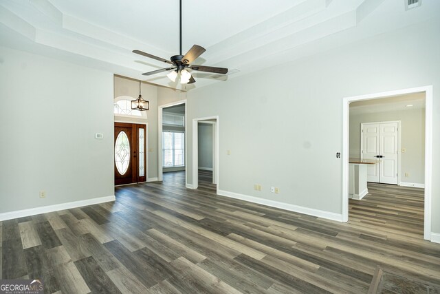 unfurnished living room featuring ceiling fan and dark hardwood / wood-style floors